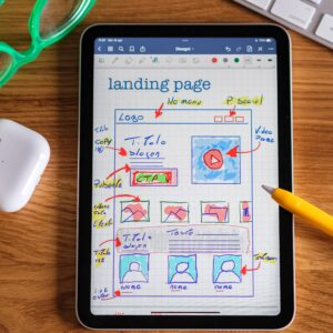Close-up of tablet showing a hand-drawn landing page design, ideal for web development concepts.